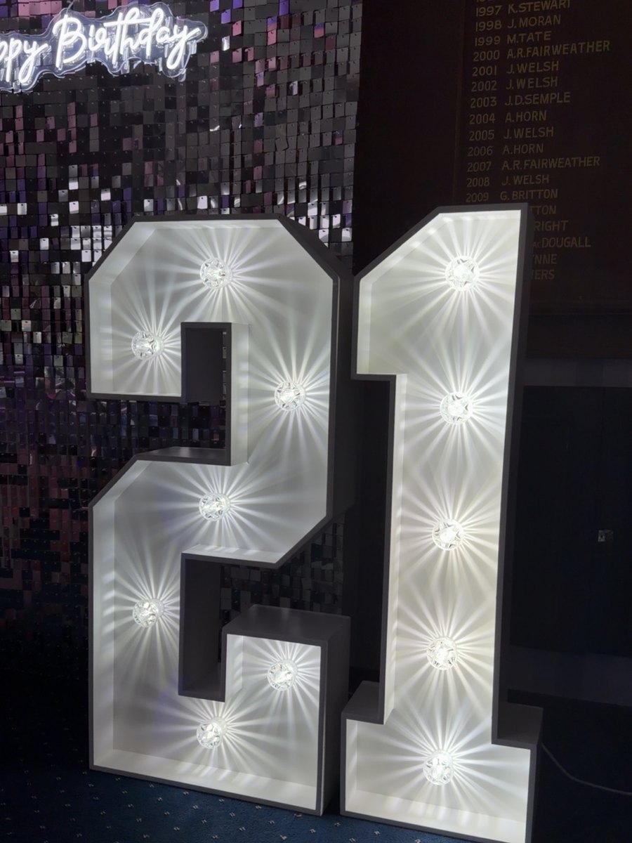 Illuminated 4ft LED marquee number 21 against a sequin wall at a Glasgow party